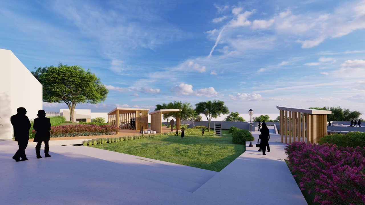 Vista aérea del Parque Pulmón Verde con senderos, jardines y estructuras sostenibles en una ladera boscosa.