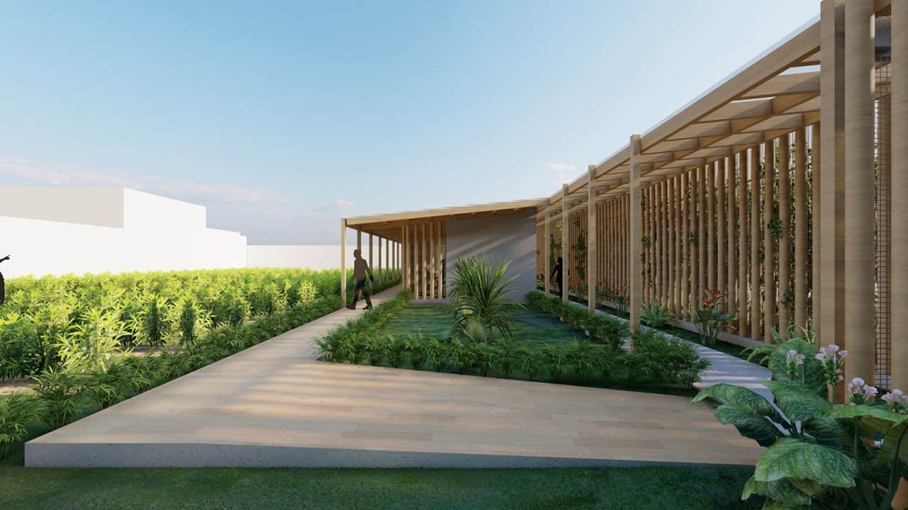 Vista aérea del Parque Pulmón Verde con senderos, jardines y estructuras sostenibles en una ladera boscosa.