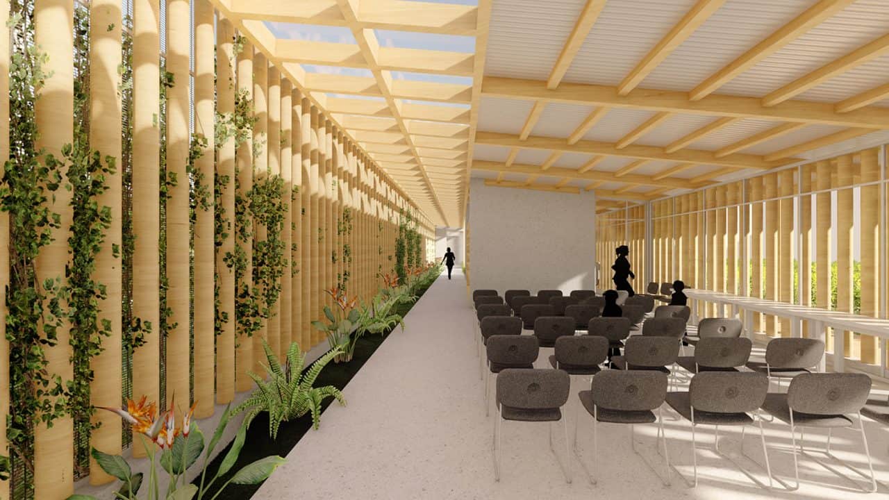 Vista aérea del Parque Pulmón Verde con senderos, jardines y estructuras sostenibles en una ladera boscosa.