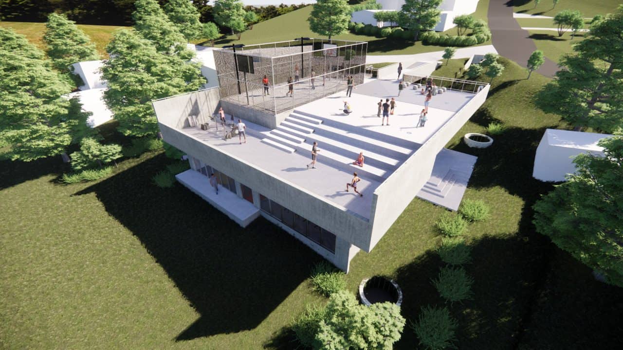 Vista de la plaza superior y puente peatonal del Centro de Desarrollo Humano de Matinilla, integrado al paisaje montañoso.