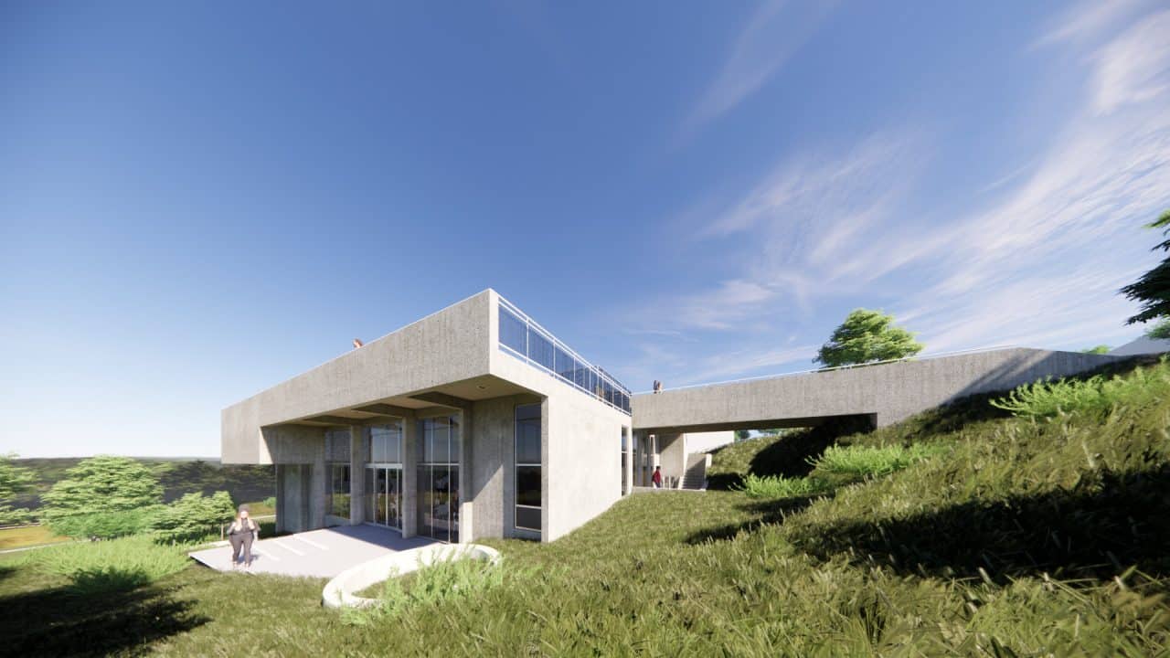 Vista de la plaza superior y puente peatonal del Centro de Desarrollo Humano de Matinilla, integrado al paisaje montañoso.