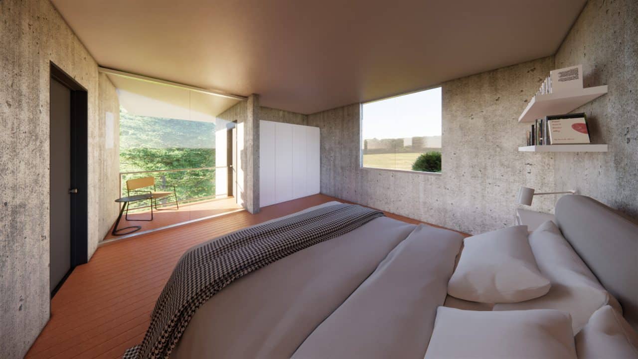 Vista de vivienda en pendiente con ventanales y conexión al bosque.