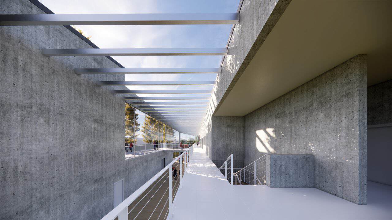 Vista interior del laboratorio experimental del Centro Atómico Bariloche con doble altura y luz natural.