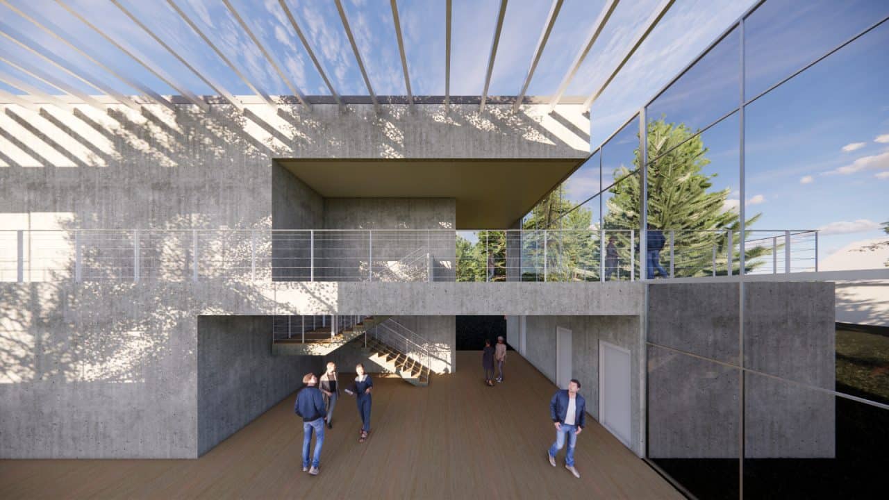 Vista interior del laboratorio experimental del Centro Atómico Bariloche con doble altura y luz natural.