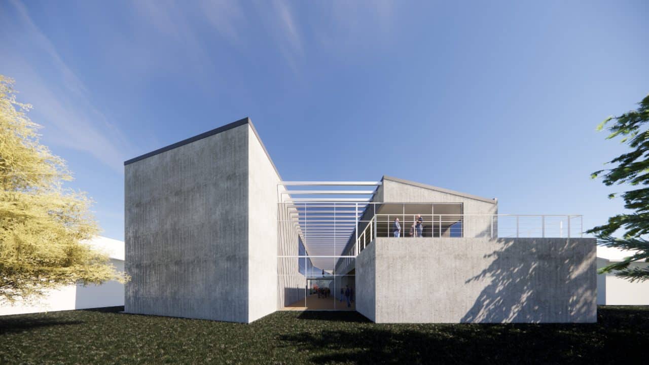 Vista interior del laboratorio experimental del Centro Atómico Bariloche con doble altura y luz natural.