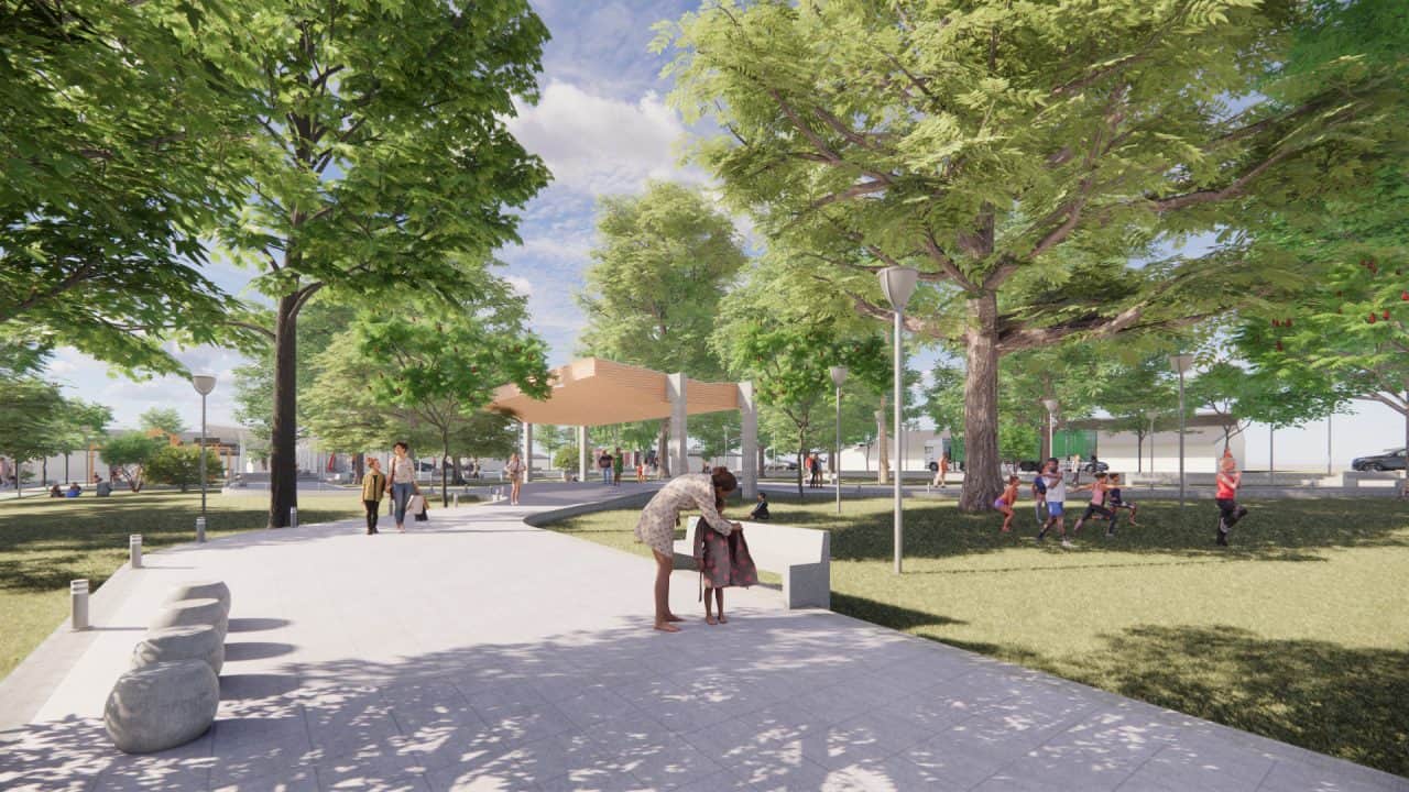 Vista del Parque Central Campo 5 con plaza, cancha cubierta y áreas verdes en la ruta a Tortuguero.