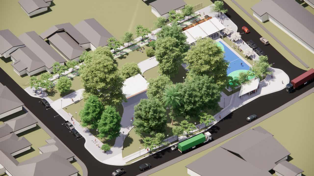 Vista del Parque Central Campo 5 con plaza, cancha cubierta y áreas verdes en la ruta a Tortuguero.