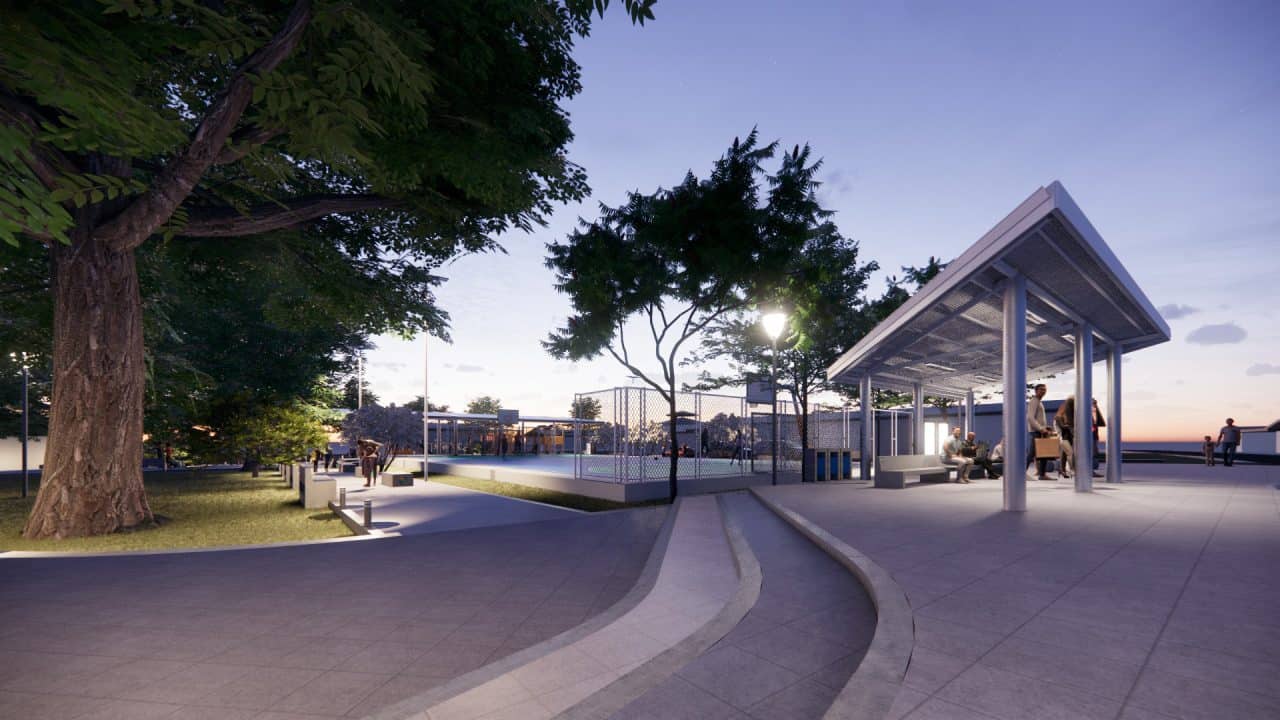 Vista del Parque Central Campo 5 con plaza, cancha cubierta y áreas verdes en la ruta a Tortuguero.