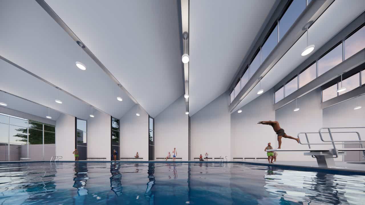 Piscinas Públicas de Grecia con volumen en diente de sierra y luz cenital Vista interior de la piscina semiolímpica con gradería y ventilación cruzada Acceso con plaza, escalera‑anfiteatro y vestíbulo de doble altura Fachada roja de Piscinas Públicas de Grecia iluminada de noche