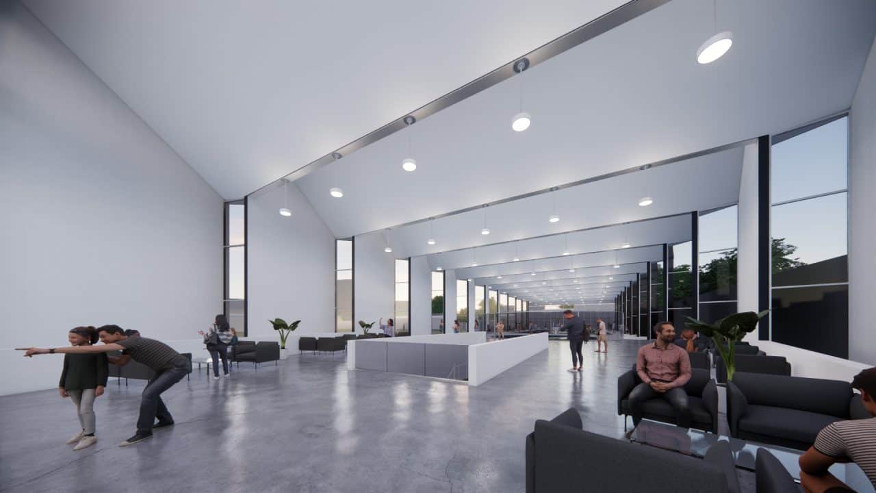 Piscinas Públicas de Grecia con volumen en diente de sierra y luz cenital Vista interior de la piscina semiolímpica con gradería y ventilación cruzada Acceso con plaza, escalera‑anfiteatro y vestíbulo de doble altura Fachada roja de Piscinas Públicas de Grecia iluminada de noche