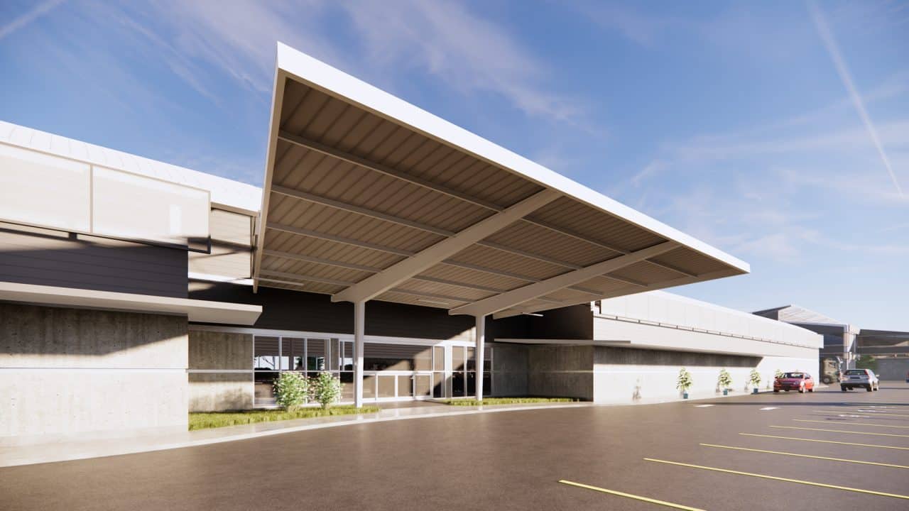 Vista exterior de tienda de flores en Lindora con techo curvo y ventanal posterior.