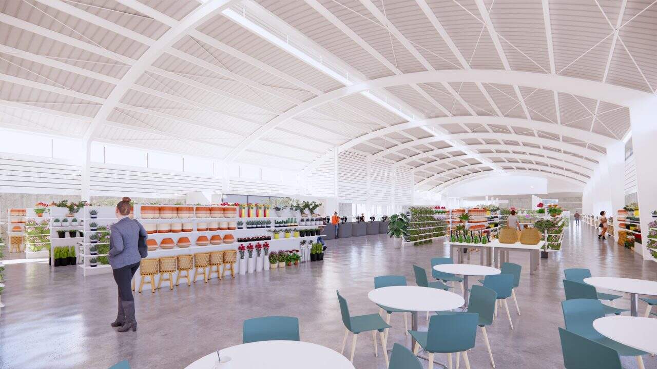 Vista exterior de tienda de flores en Lindora con techo curvo y ventanal posterior.