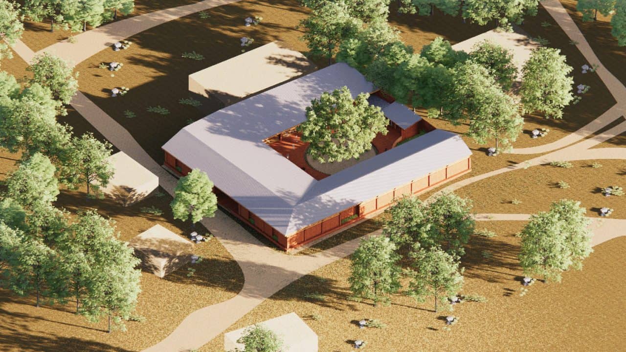 Vista de la Escuela Primaria de Marsassoum con patio central y árbol simbólico rodeado por aulas y espacios comunitarios.