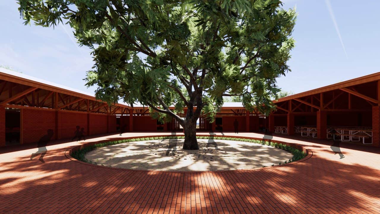 Vista de la Escuela Primaria de Marsassoum con patio central y árbol simbólico rodeado por aulas y espacios comunitarios.