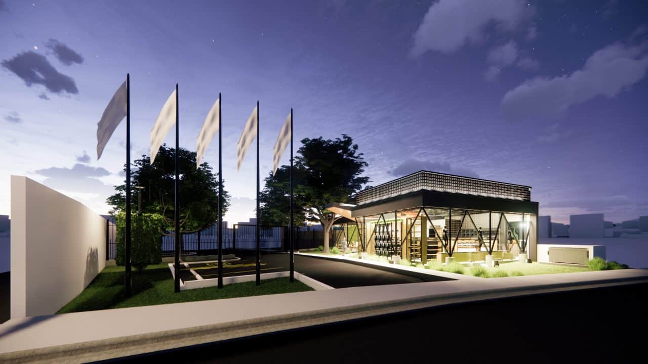 Tienda institucional con techo en forma de llama y cafetería junto a un árbol integrado al diseño.