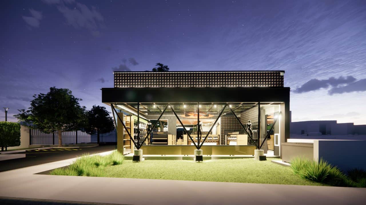 Tienda institucional con techo en forma de llama y cafetería junto a un árbol integrado al diseño.