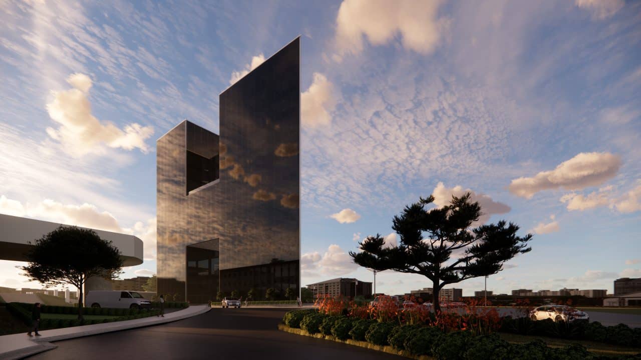 Vista del edificio triangular en el Valle Central con terrazas y fachadas de vidrio.