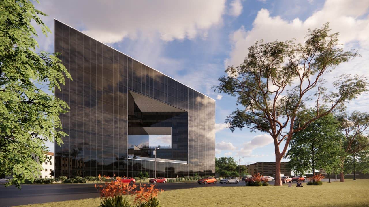 Vista del edificio triangular en el Valle Central con terrazas y fachadas de vidrio.