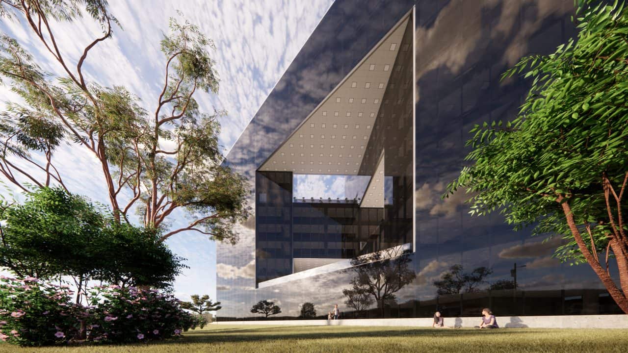 Vista del edificio triangular en el Valle Central con terrazas y fachadas de vidrio.