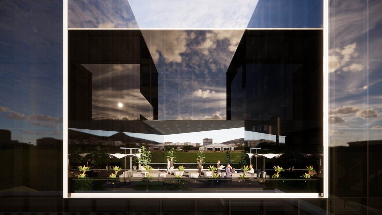 Vista del edificio triangular en el Valle Central con terrazas y fachadas de vidrio.